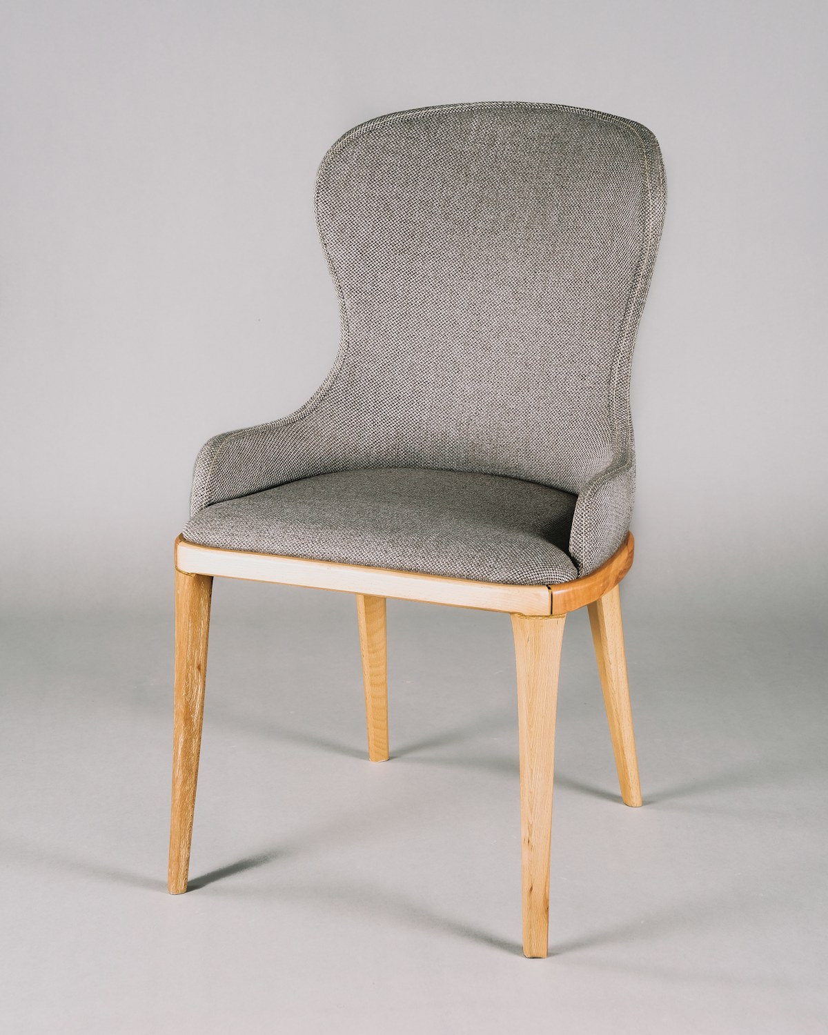 Comfortable oatmeal bouclé armchair in an architecturally styled room